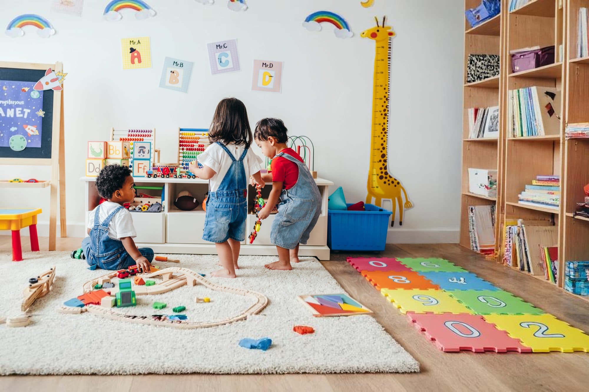 Toddlers playing in a colorful Kids Discovery classroom